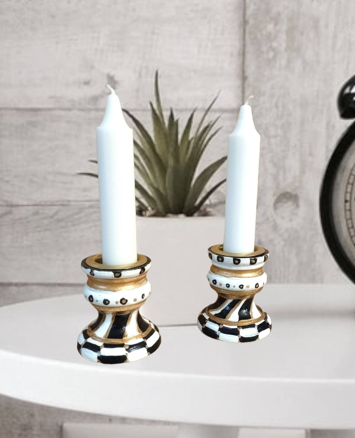 Golda Hand-Painted Shabbat Candlesticks, Golda candlesticks with white candles on a shelf