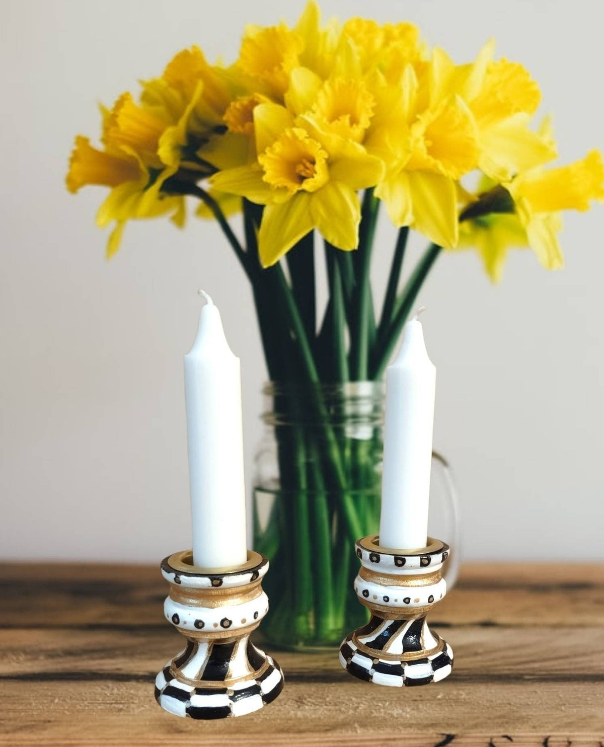 Golda Hand-Painted Shabbat Candlesticks, Golda candlesticks beside yellow daffodils
