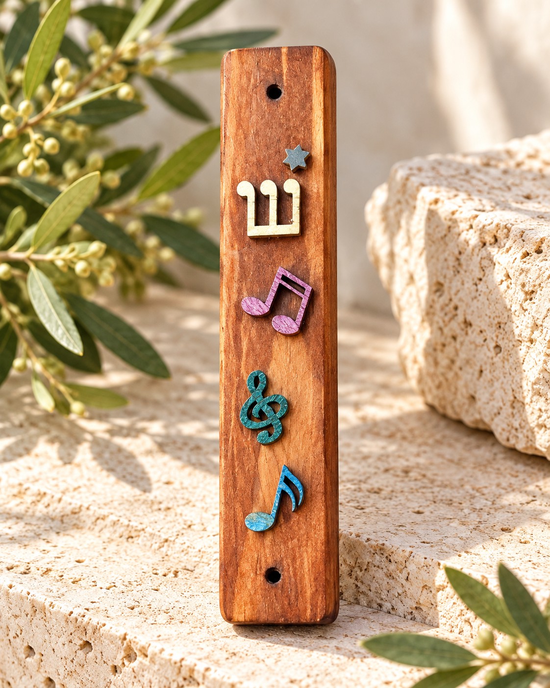 Wood mezuzah case with colourful music notes on stone