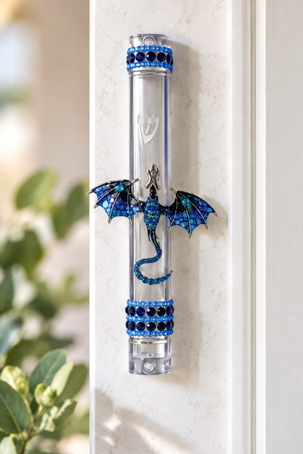 Blue jeweled dragon mezuzah case on a doorpost