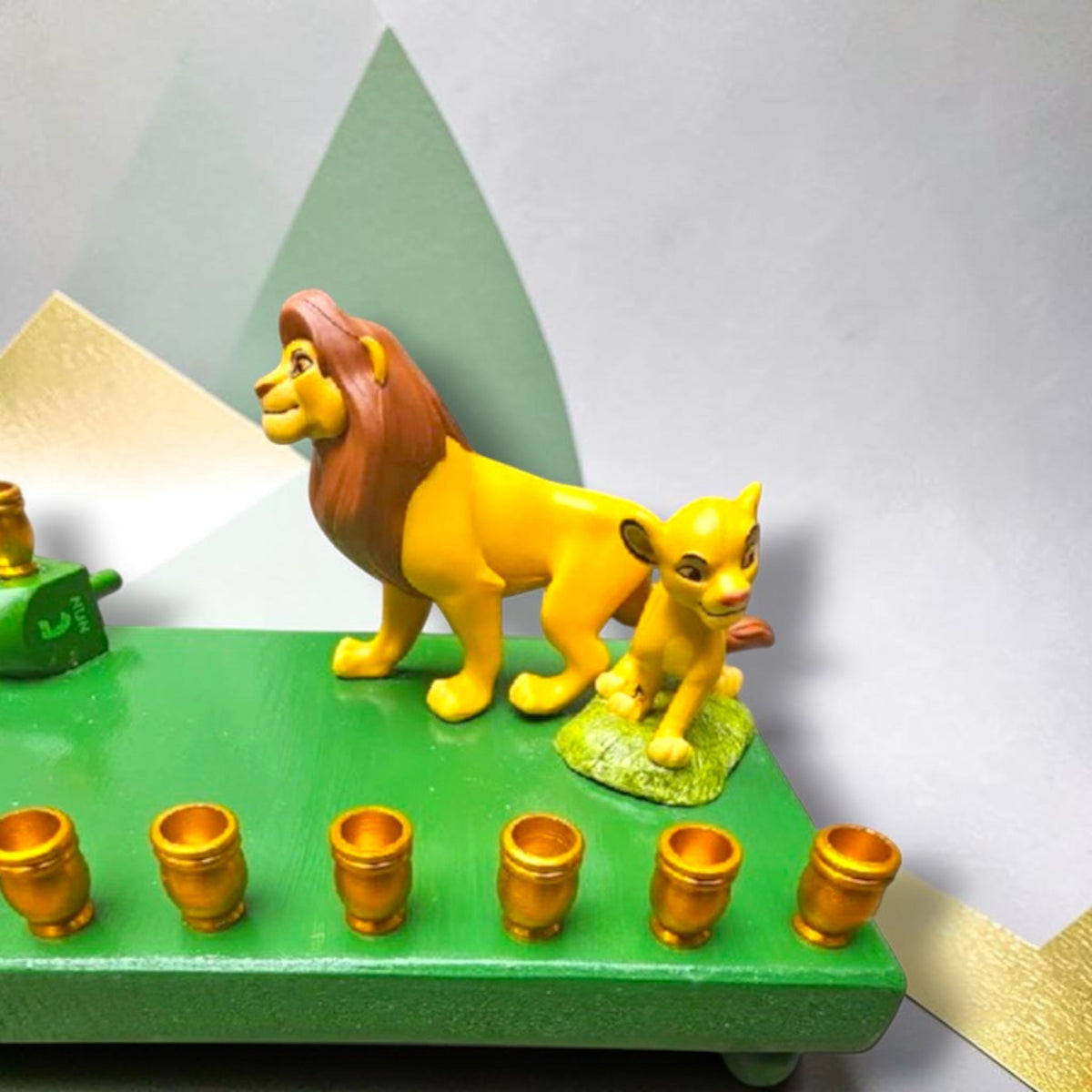 Lion King Simba & Mufasa Menorah, close-up of the Simba and Mufasa figures and gold candle cups