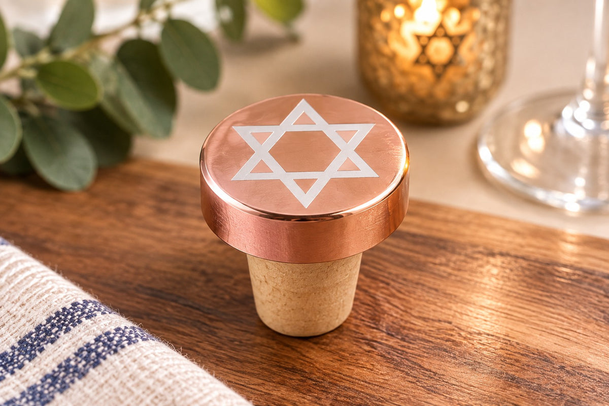 Metallic Star of David Wine Bottle Stopper, rose gold Star of David stopper on a wood table