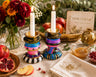 Mitzi, mismatched hand-painted candlesticks on a Rosh Hashanah table