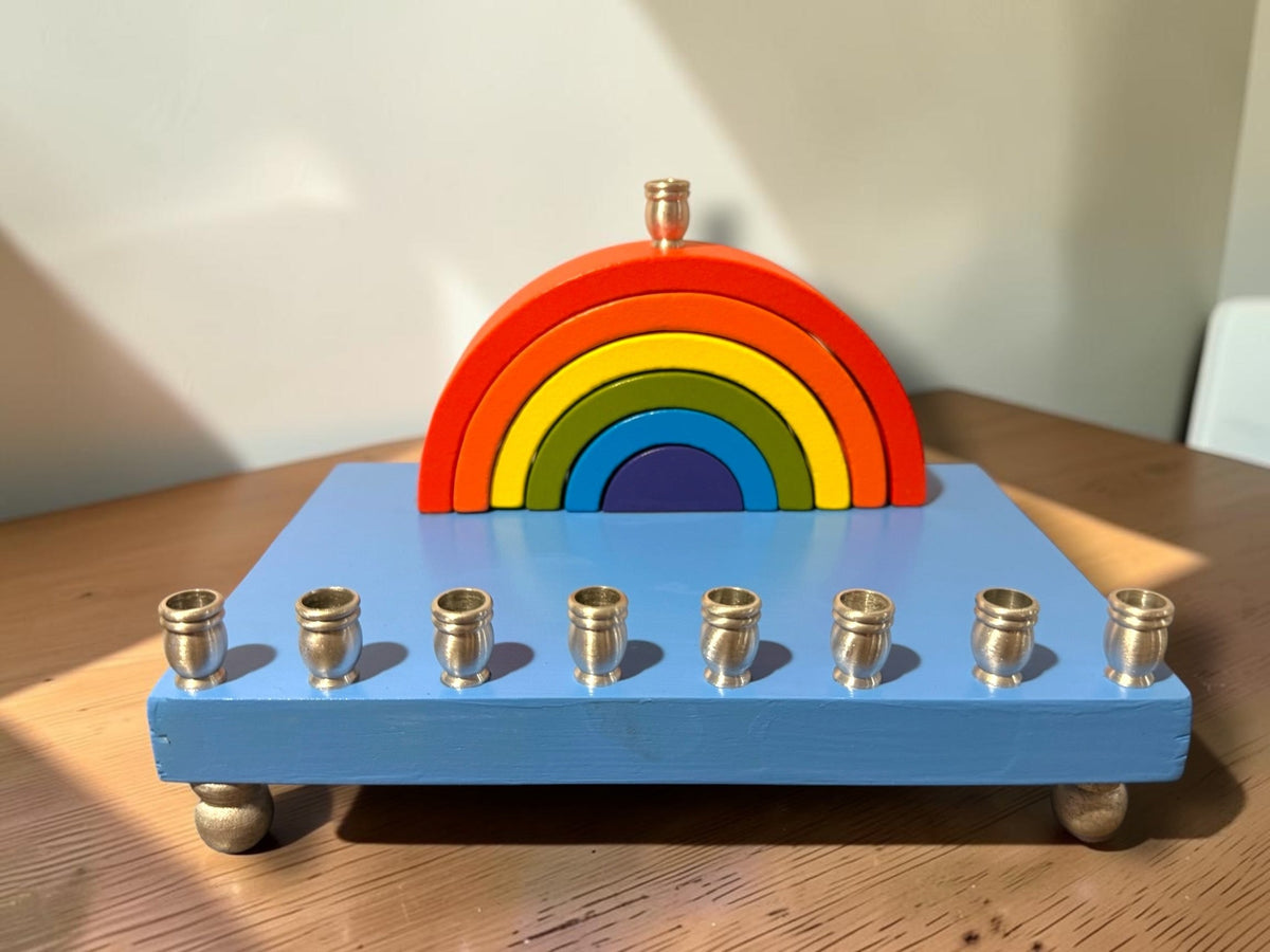 Rainbow wood menorah on a wood table