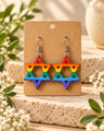 Rainbow Star of David wood earrings on a kraft card