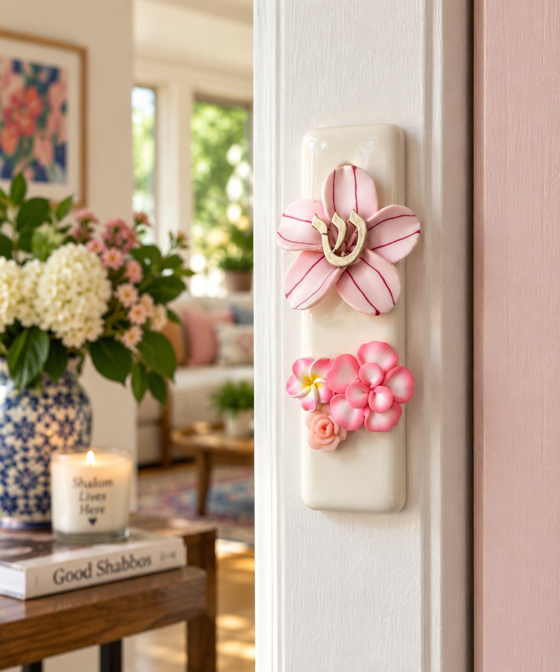 Shalom in Bloom Ceramic Mezuzah, pink floral ceramic mezuzah on a doorpost