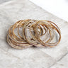 Shalom Peace Bracelet, stack of gold sparkle bangles on marble (Rhinestone only)