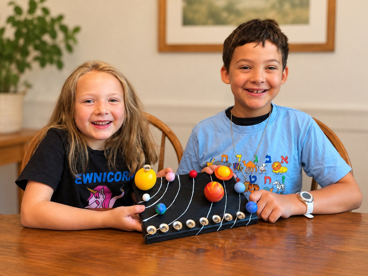 Solar System Menorah Kit, two children with the finished menorah