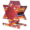 Red cast aluminum Star of David menorah standing on a base, with colored candles set in the frame