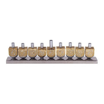 Emanuel menorah of nine brass-tone cutout dreidels with silver candle holders on a low silver base