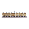 Emanuel menorah of nine brass-tone cutout dreidels with silver candle holders on a low silver base