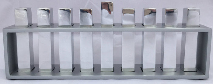 Emanuel menorah with nine square silver branches standing inside an open rectangular silver frame