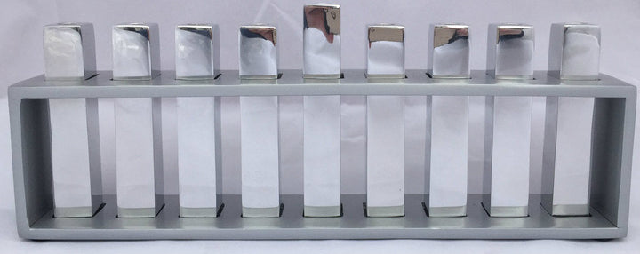 Emanuel menorah with nine square silver branches standing inside an open rectangular silver frame