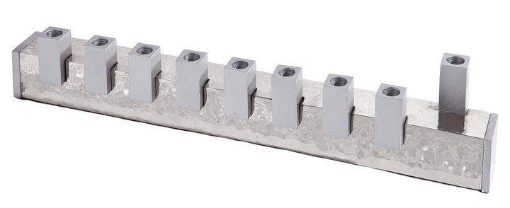 Emanuel menorah with nine square silver holders on a long hammered silver base, taller end shamash