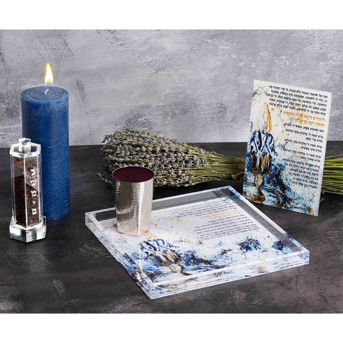 Havdalah table with the besamim holder, braided blue candle, lavender, silver cup and artwork tray