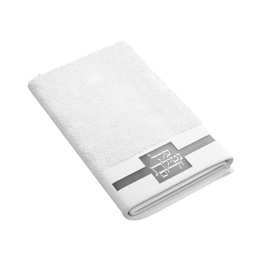Folded white towel with silver band and embroidered Al Netilas Yadayim monogram