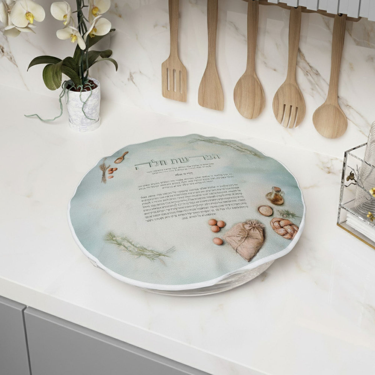 Blue Harmony cover drawn over a dough bowl on a marble counter below hanging wooden utensils