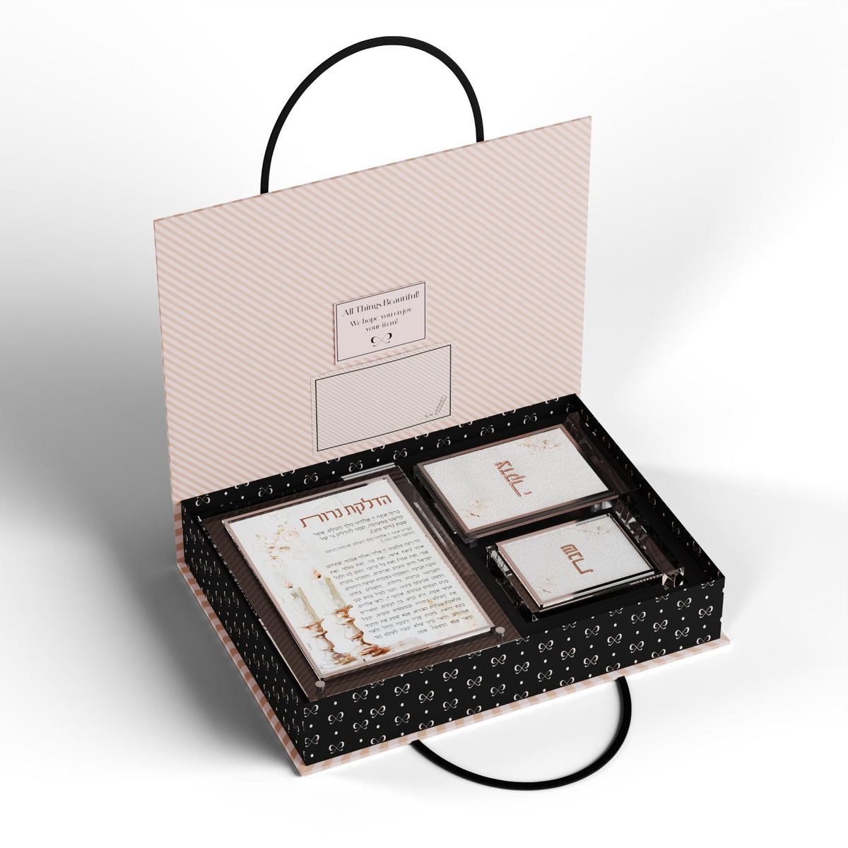 Open pink FeldArt gift box holding the Blush Rose card, tzedakah box and match holder in fitted slots