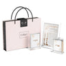 Blush Rose Hadlakos Neiros card, tzedakah box and match holder with pink floral art beside a FeldArt gift bag