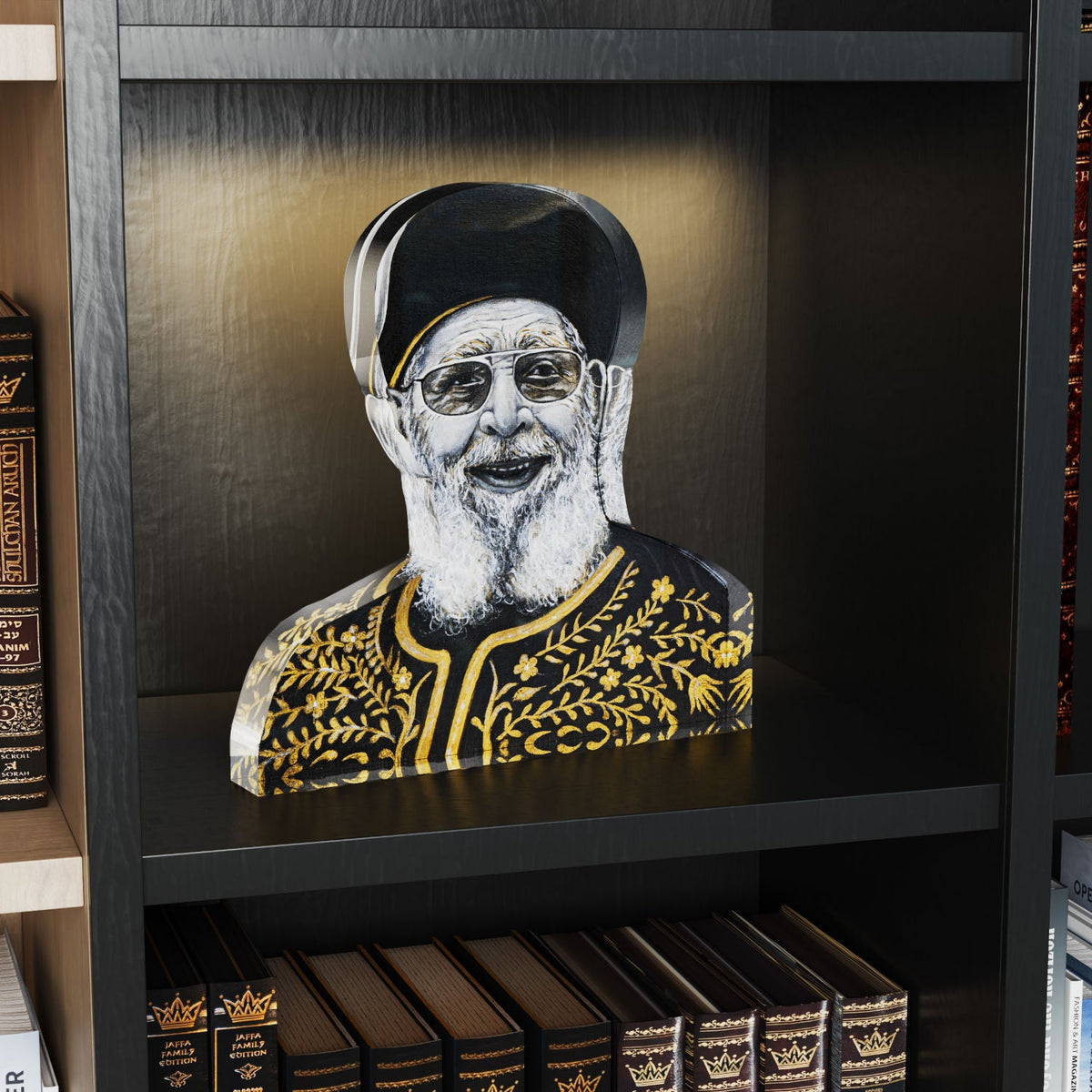 Chacham Ovadia Yosef block standing on a lit dark bookshelf above rows of sefarim