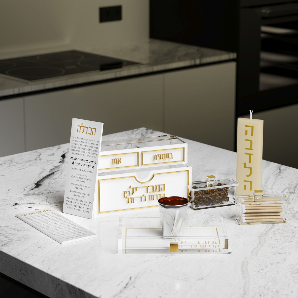 Gold set unpacked on marble with card, candle, tray, besamim and matches, shown with a cup