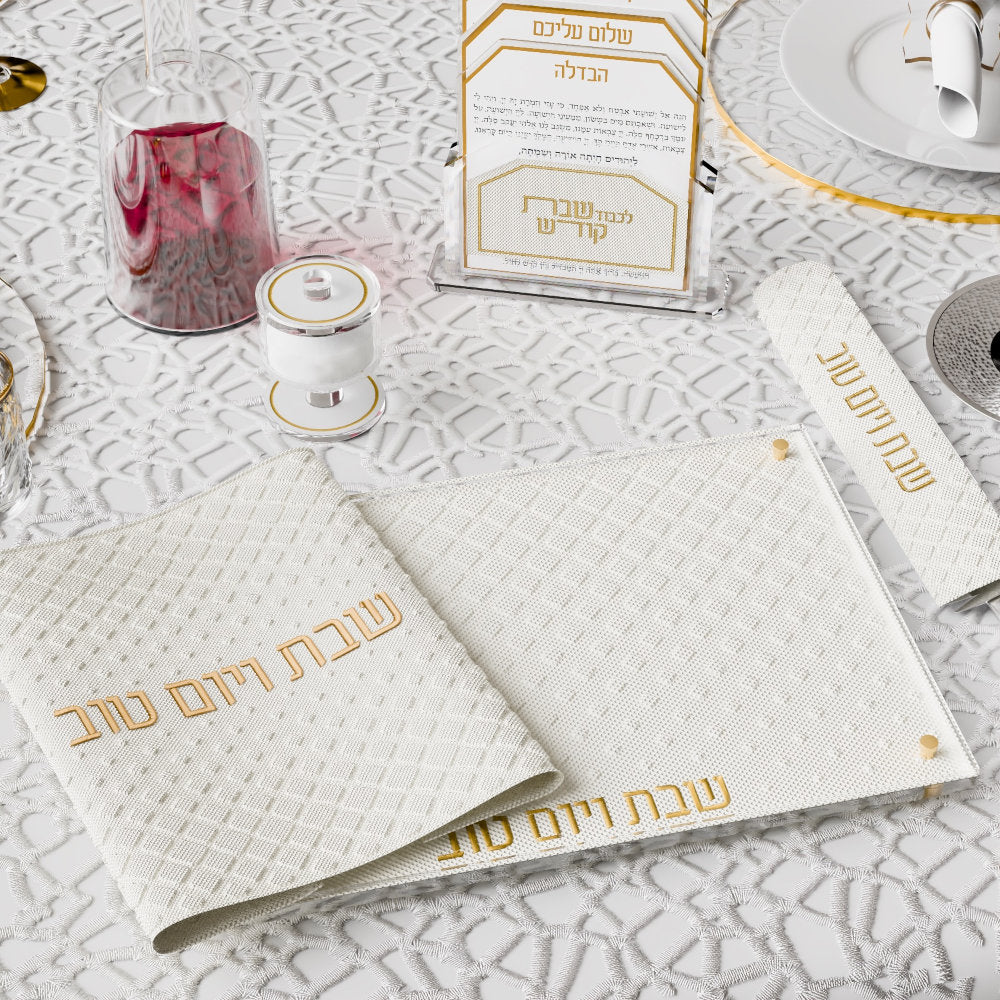 Gold board and matching challah cover beside a Havdalah card holder and kiddush wine