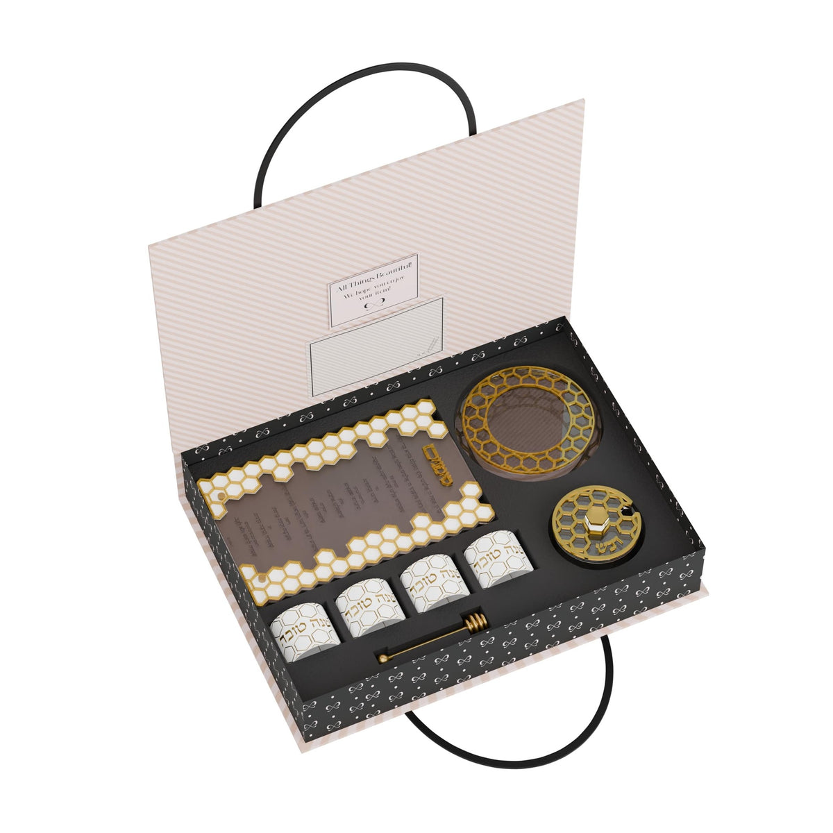 Open gift box with the simanim card, honey dish, lid and four napkin rings in fitted slots