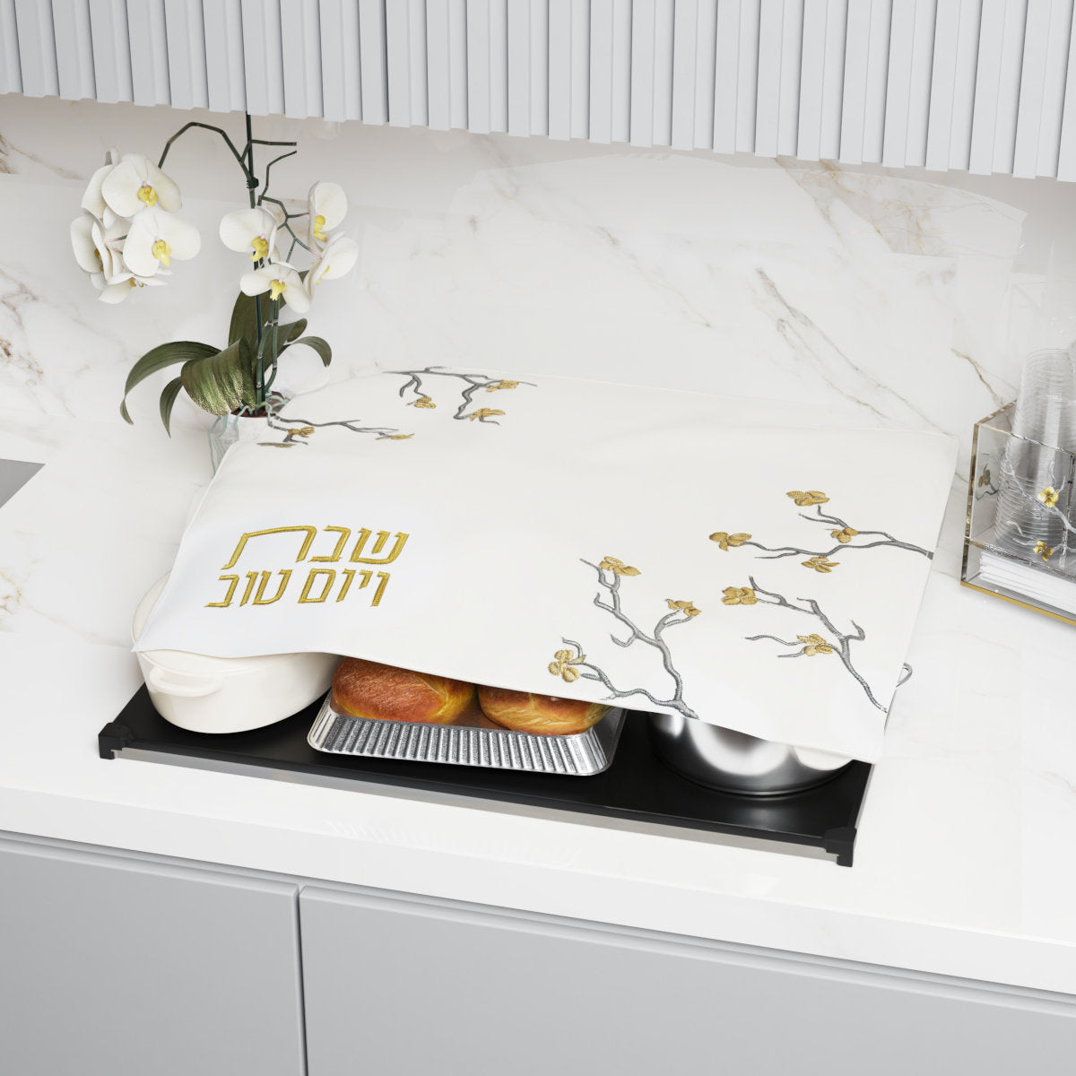 Hot plate cover draped over pans of food on a hot plate on a kitchen counter