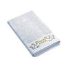 Golden Branch Pesach hand towel folded, with gold Pesach lettering and blossom branches on the band