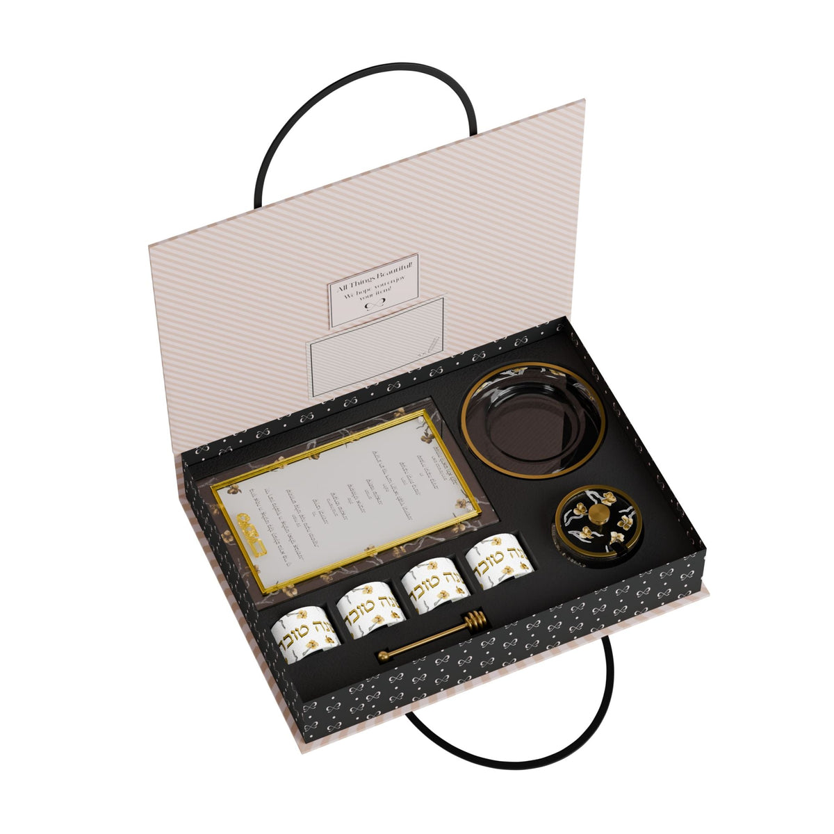 Open FeldArt gift box with the simanim card, four napkin rings, honey dish parts and spoon in fitted slots
