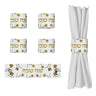 Four Golden Branch Shana Tova napkin rings, one open flat showing metal clasps, one around a white napkin