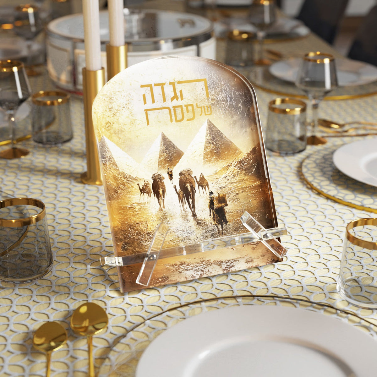 Haggadah stand on a set seder table among gold-rimmed glasses and candlesticks