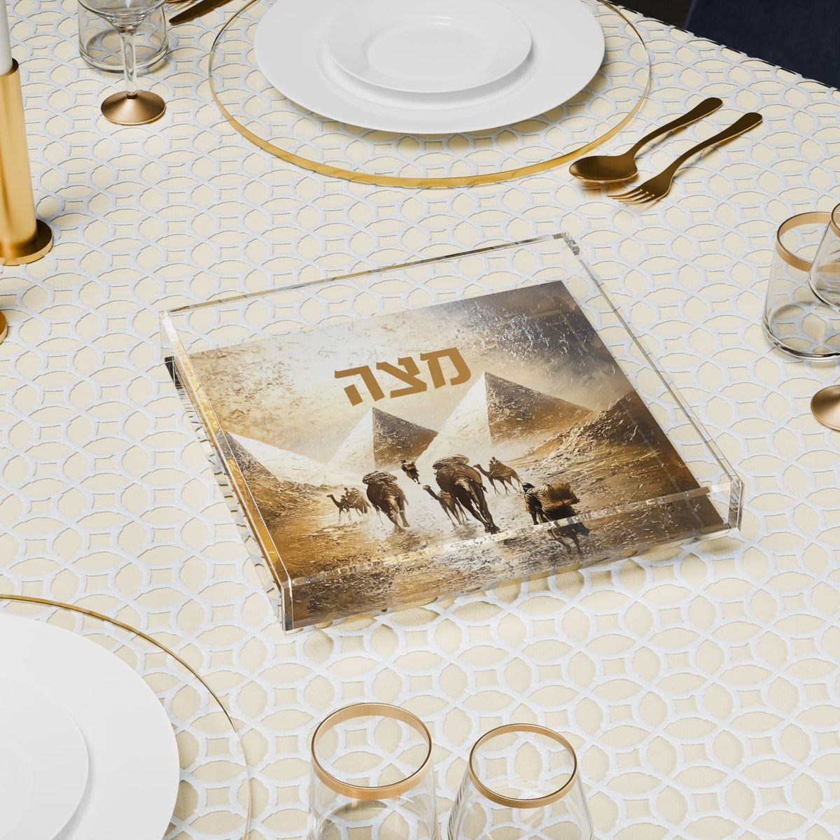 Matzah plate on a set seder table between gold-rimmed plates and glasses