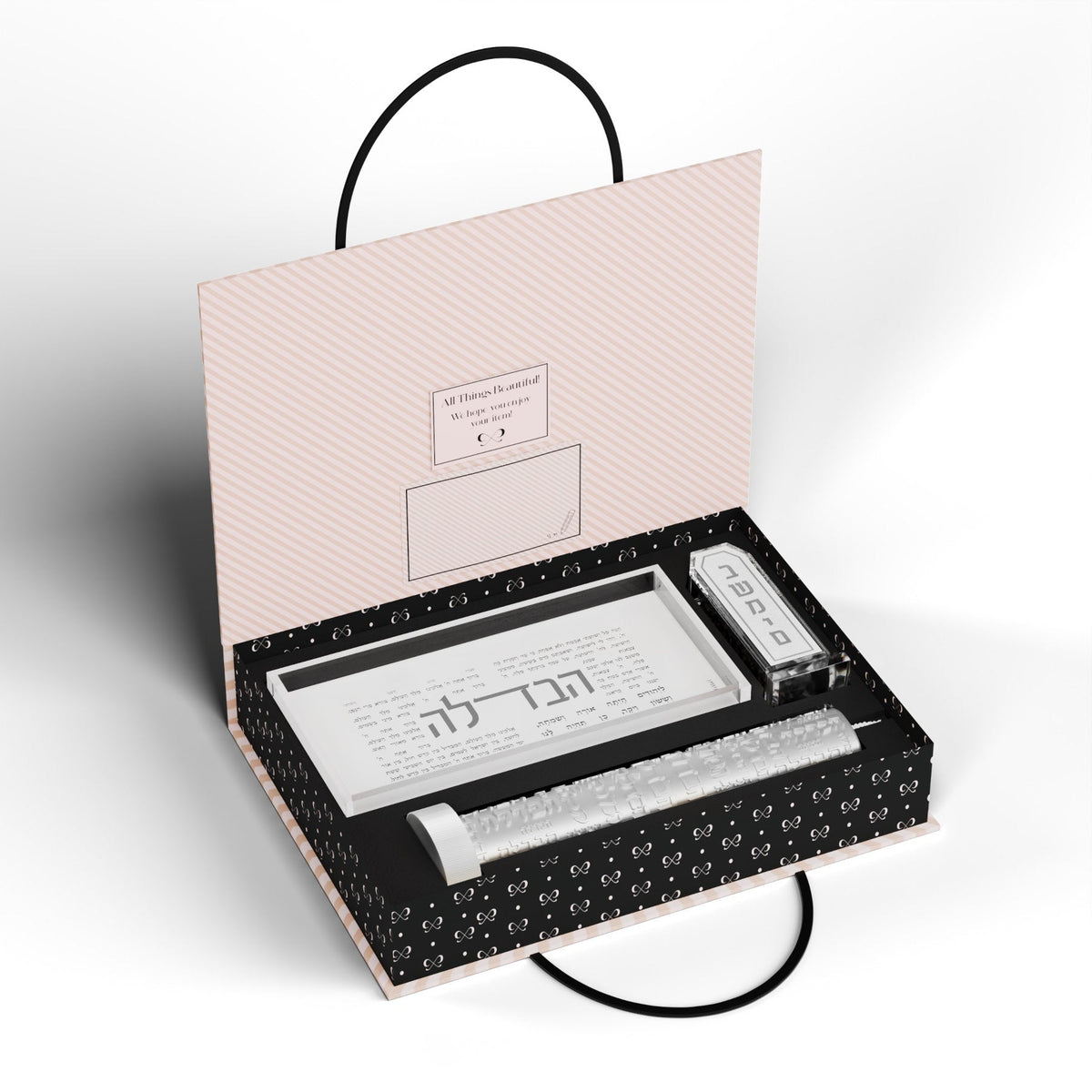 Silver set packed inside the open black and pink gift box with handle