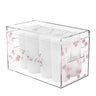 Clear acrylic towel box with pink hydrangea petals in the walls, filled with rolled white towels