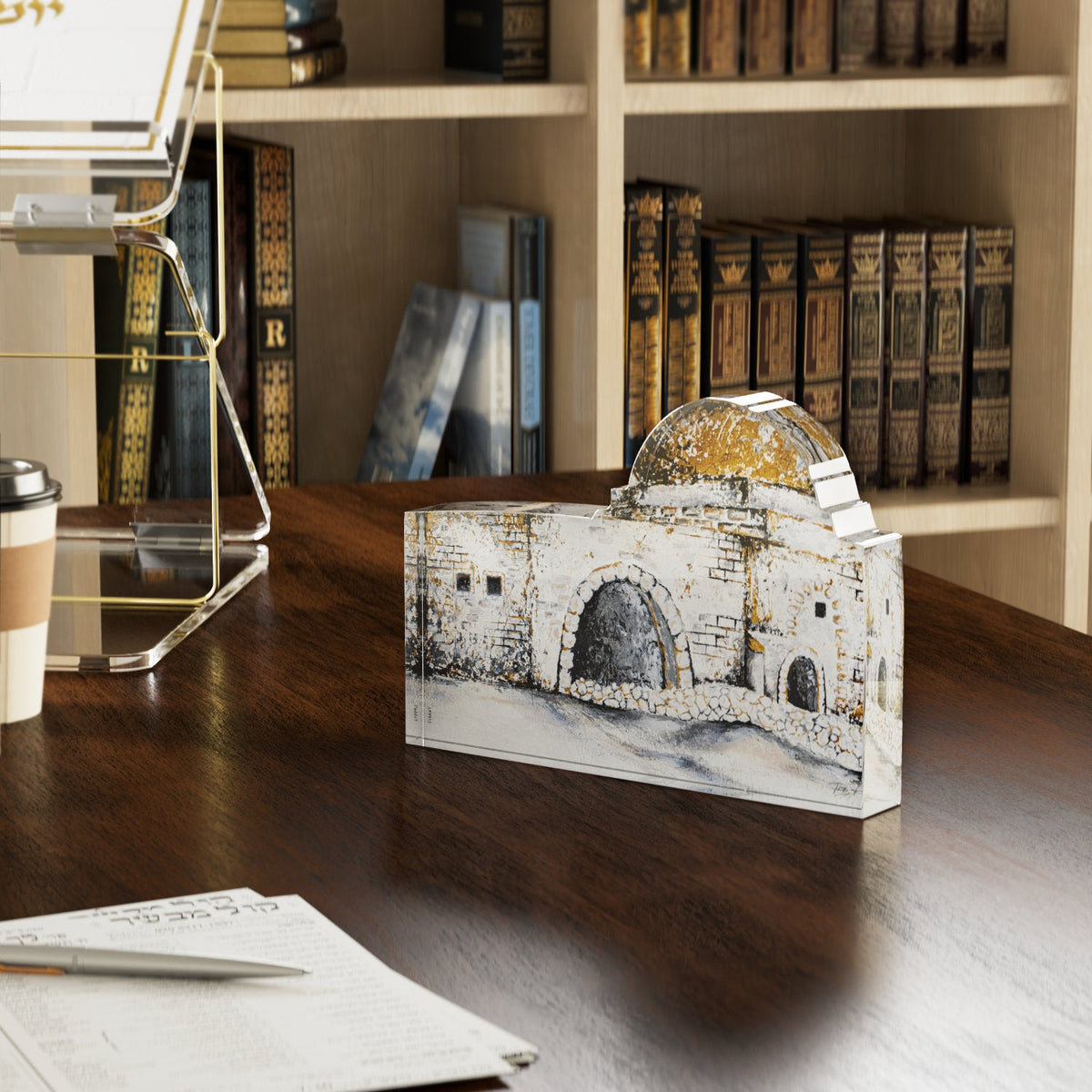 Kever Rochel block on a dark wood desk in front of a bookcase of seforim