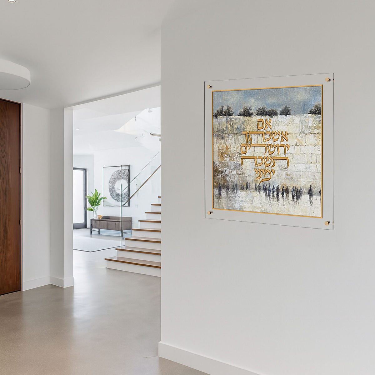 Plaque hung on a white entry wall with a staircase and living area behind