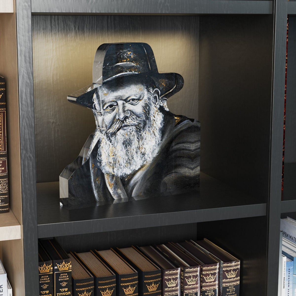 Lubavitcher Rebbe block standing on a lit bookshelf above sefarim