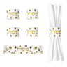 Four Ornate Garden napkin rings with gold Pesach lettering, one laid flat and one wrapped around a white napkin
