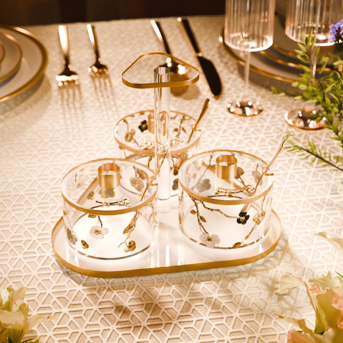 Seder dish set on a table setting beside gold cutlery, dinner plates and glassware
