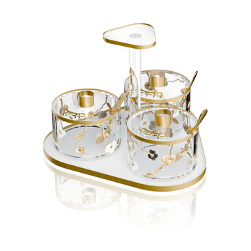 Ornate Garden Seder dish set with three floral dishes and spoons on a frosted gold-rimmed base with center handle