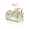 Ornate Garden Seder dish set with three floral dishes and spoons on a frosted gold-rimmed base with center handle