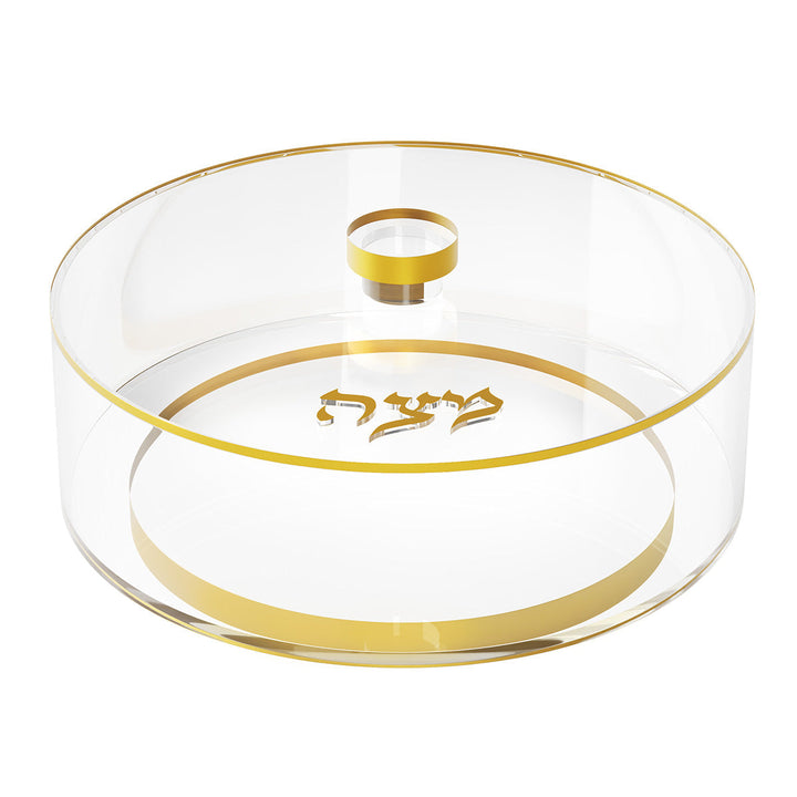 Round clear matzah box with gold rim, gold knob and gold Matzah lettering on the lid, top view