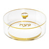 Round clear matzah box with gold rim, gold knob and gold Matzah lettering on the lid, top view