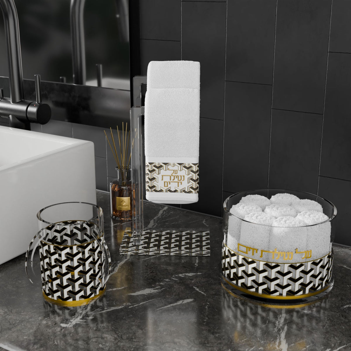 Towel stand holding an Urban Deco towel at a black-tiled sink beside cup and towel box