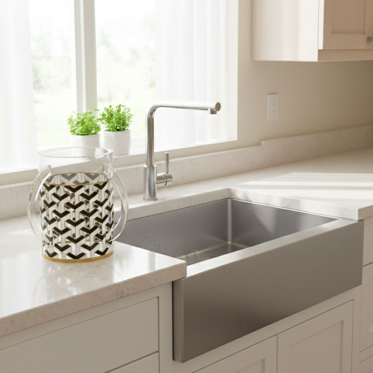 Washing cup on a kitchen counter beside a farmhouse sink and potted herbs