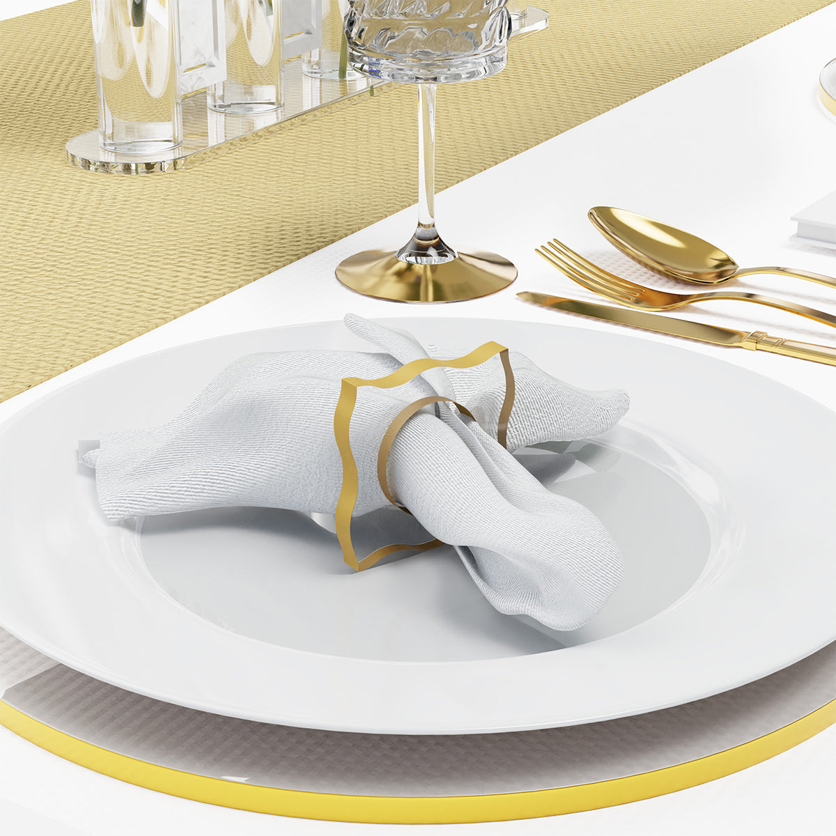 Gold napkin ring on a set place setting with gold-rim charger and gold cutlery