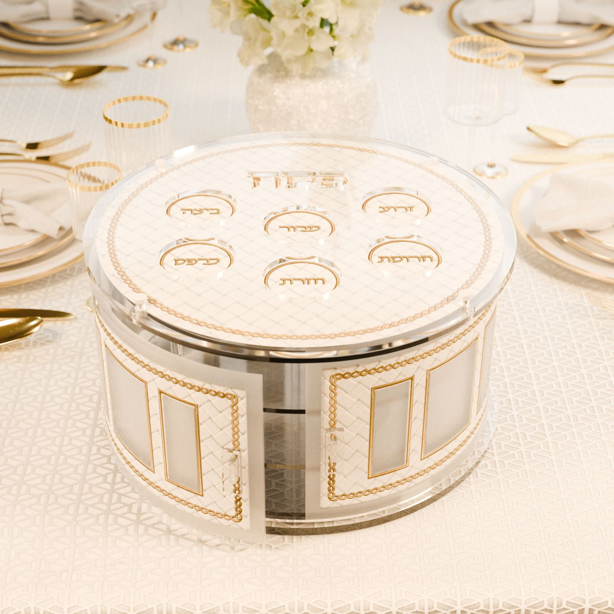 Gold tiered kearah with doors open on a set seder table