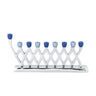 Silver aluminum menorah with a crossing diamond lattice, eight blue cups and a raised blue shamash