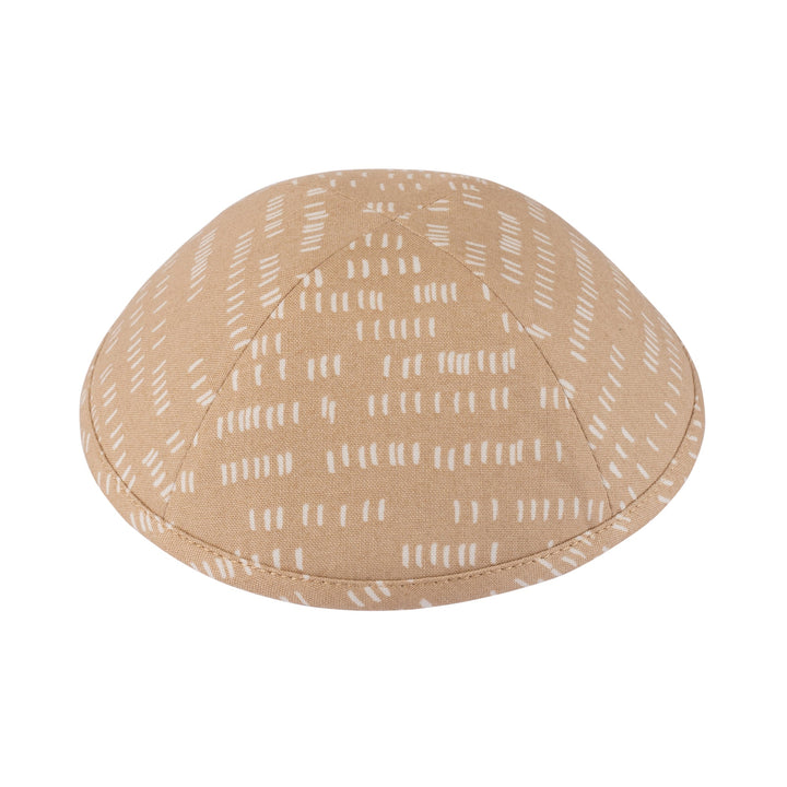Sand-beige kippah printed with rows of cream tally-mark dashes, side angle